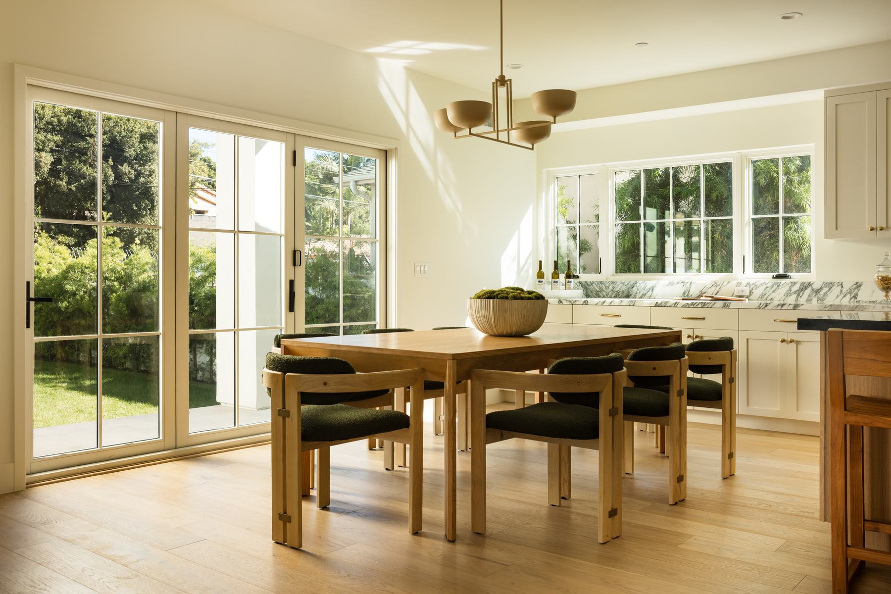 Dining room opening onto the backyard through full-width sliding glass doors